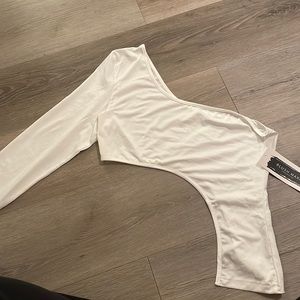 I am selling this half shoulder crop top shirt. It’s never been worn.